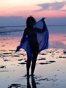 On sand seminude with light-color vase