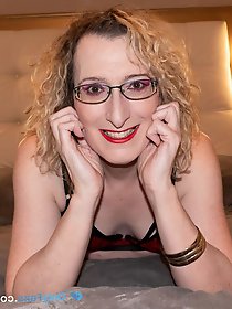 English mature beauty Lisa Essex reclining on the bed in alluring undergarments